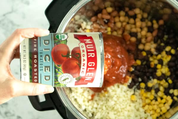 pouring canned tomatoes into the Instant Pot