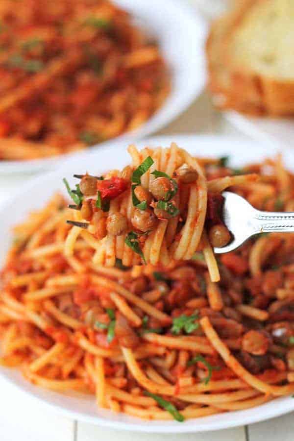 fork loaded with spaghetti bolognese on a plate