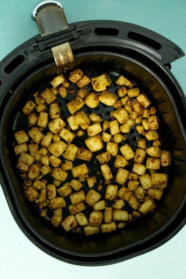 cooked crispy tofu in the air fryer basket