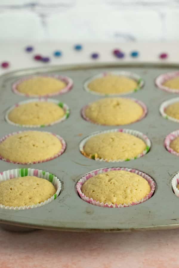 pan of cooked and completely cooled vanilla cupcakes