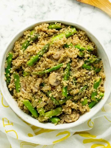 bowl of quinoa pilaf with mushrooms and asparagus