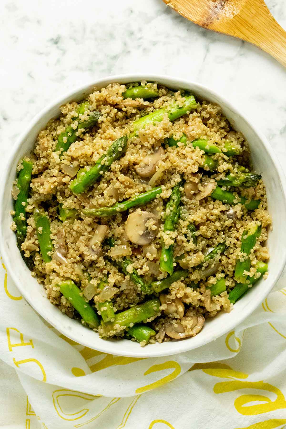 bowl of quinoa pilaf with mushrooms and asparagus