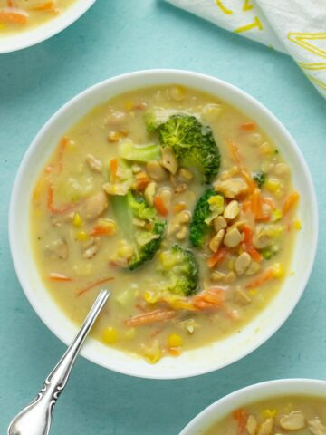 bowls of Instant Pot vegan corn chowder on a blue table