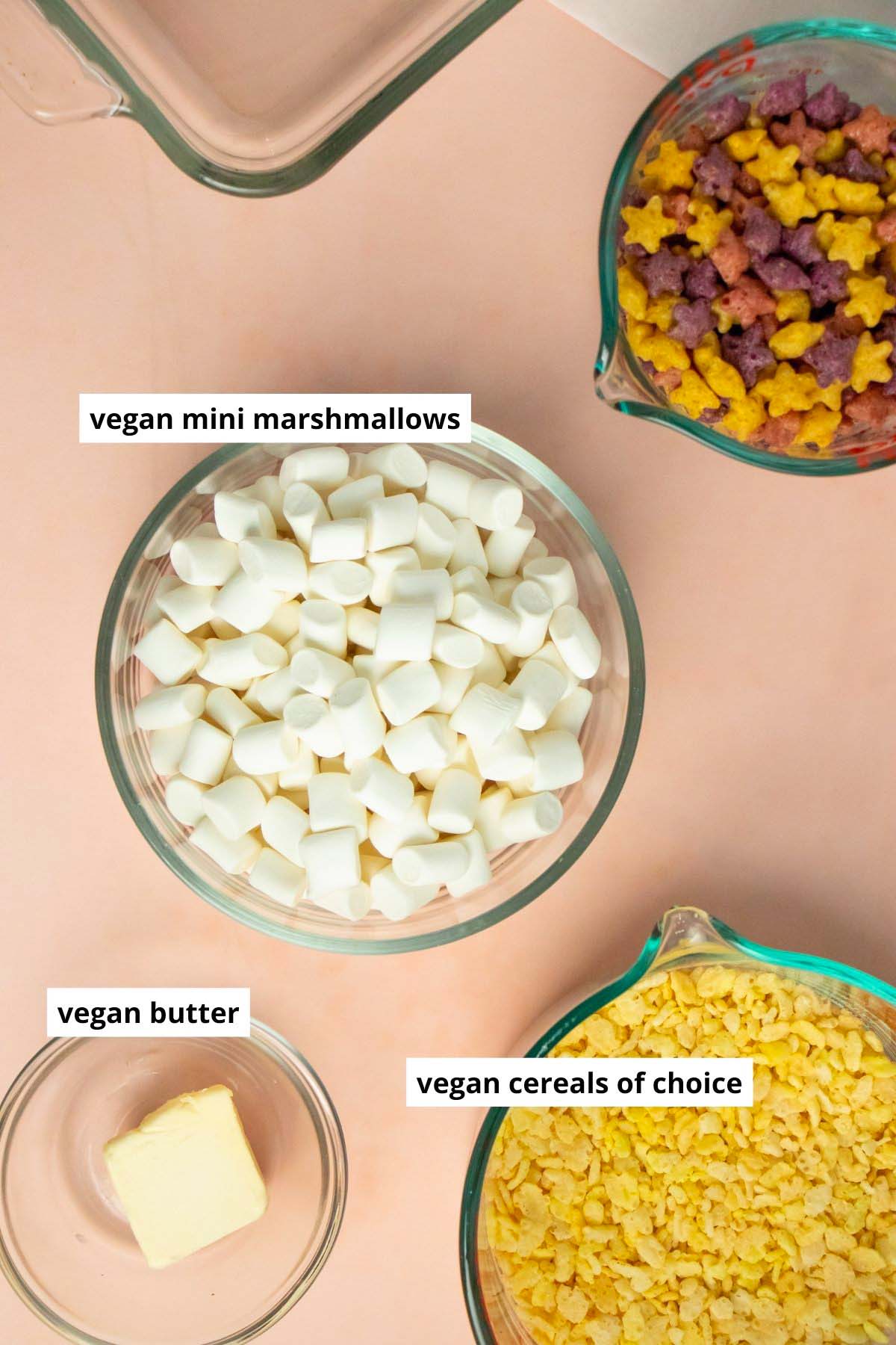 marshmallows, vegan butter, and cereal in bowls on a pink table