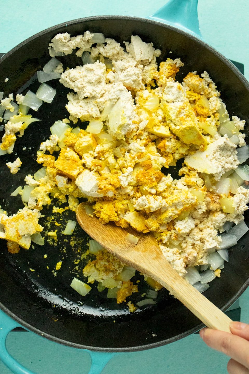 crumbled tofu in a skillet after adding dried spices and black salt