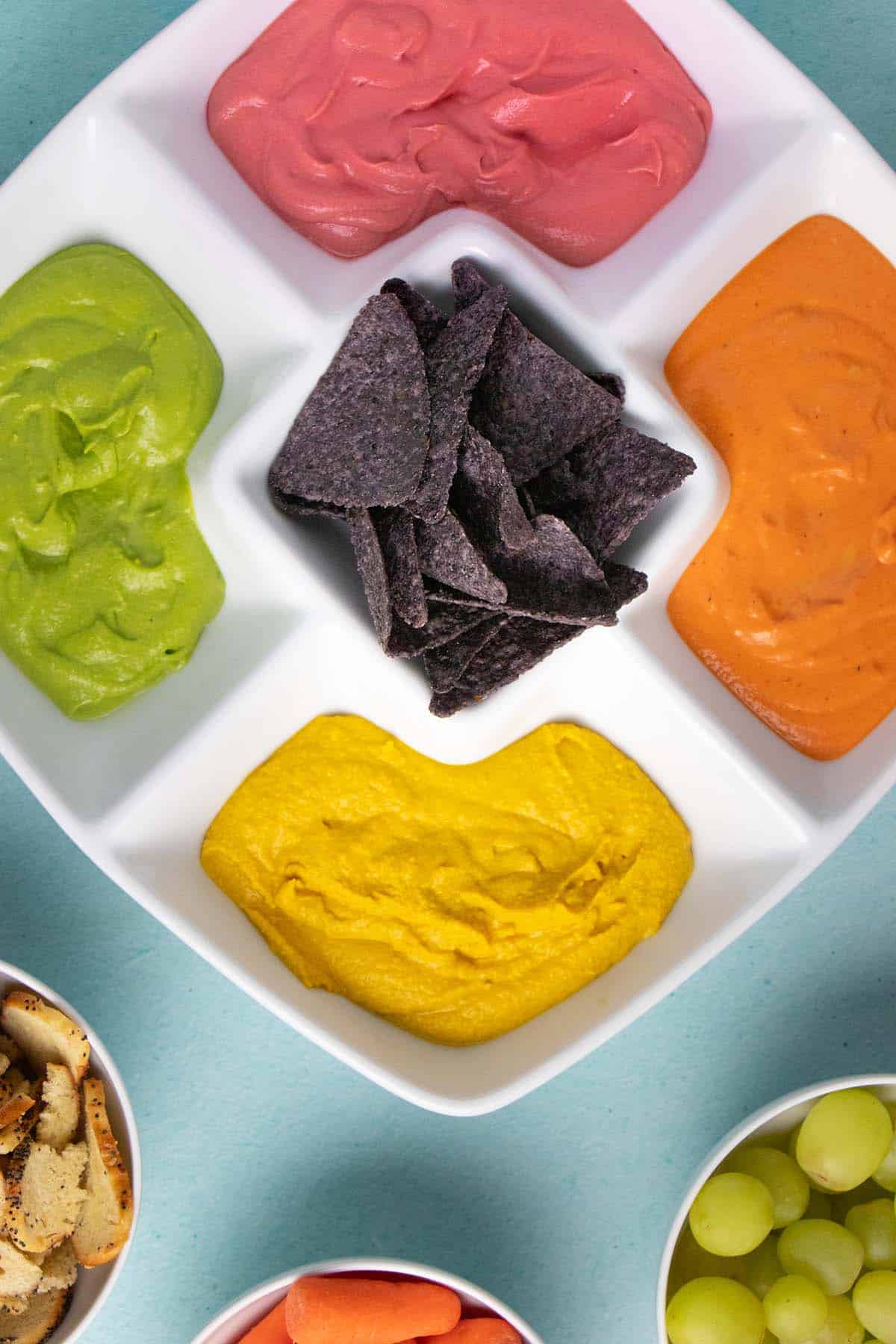 rainbow hummus in the serving tray as part of a St. Patrick's Day party spread