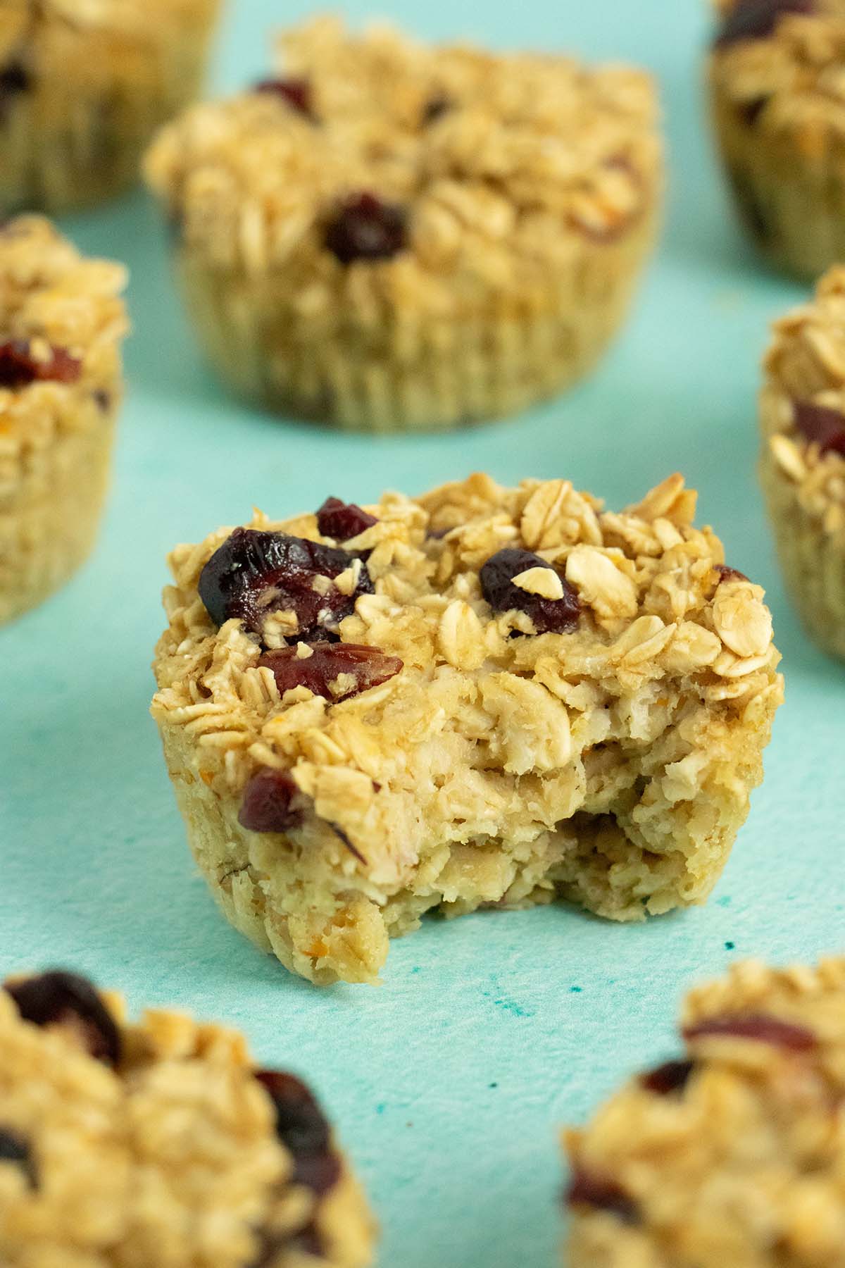 close-up of a vegan baked oatmeal cup with a bite out of it, so you can see the inside