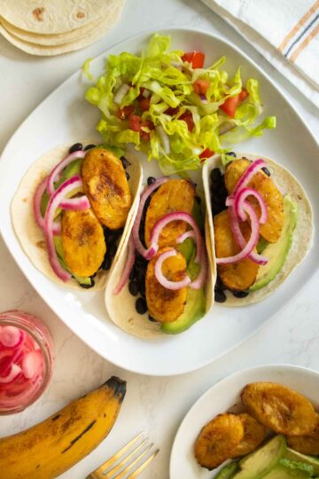 plate of plantain tacos with a side salad
