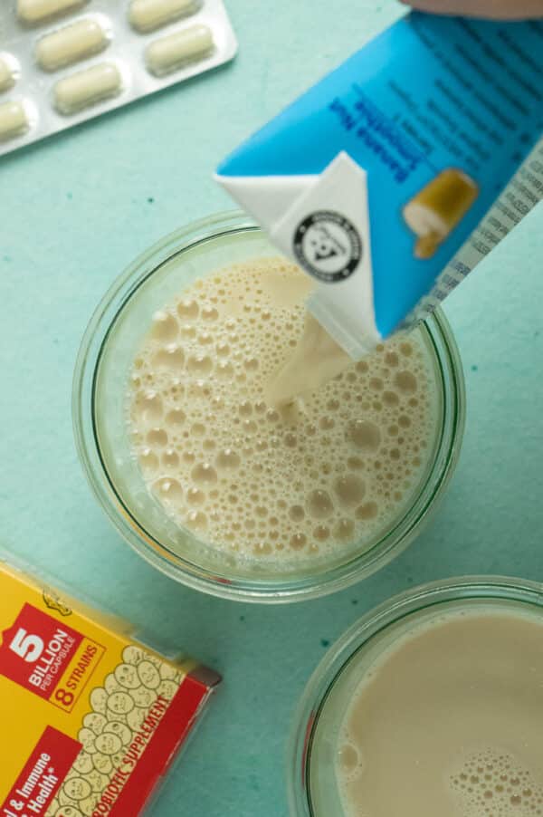 pouring soy milk into a glass jar