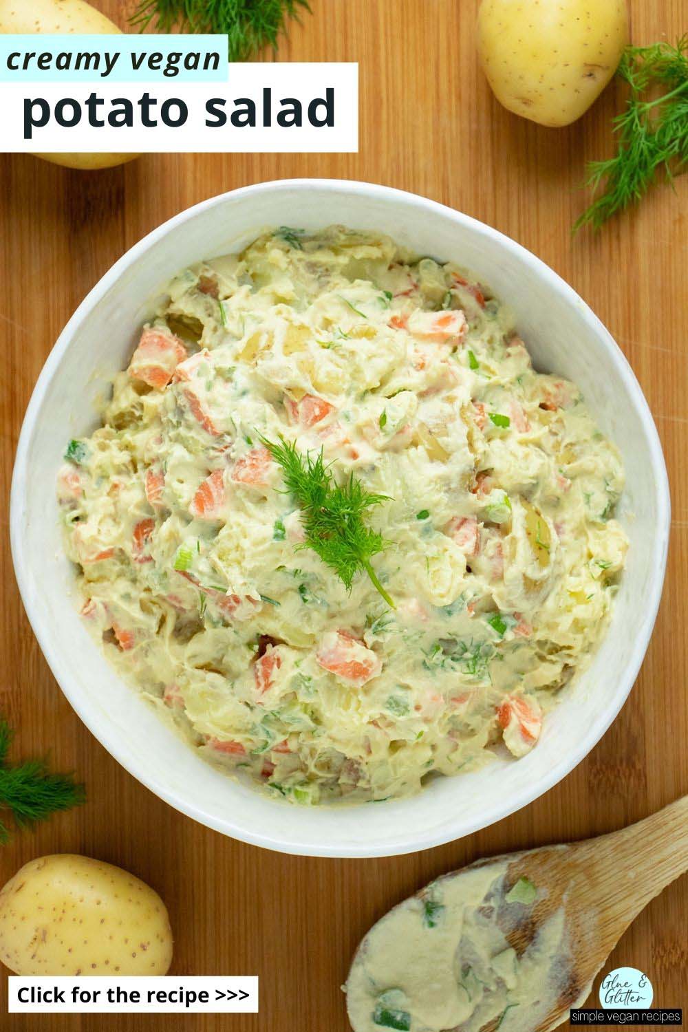 serving bowl of creamy vegan dill potato salad on a wooden table, text overlay