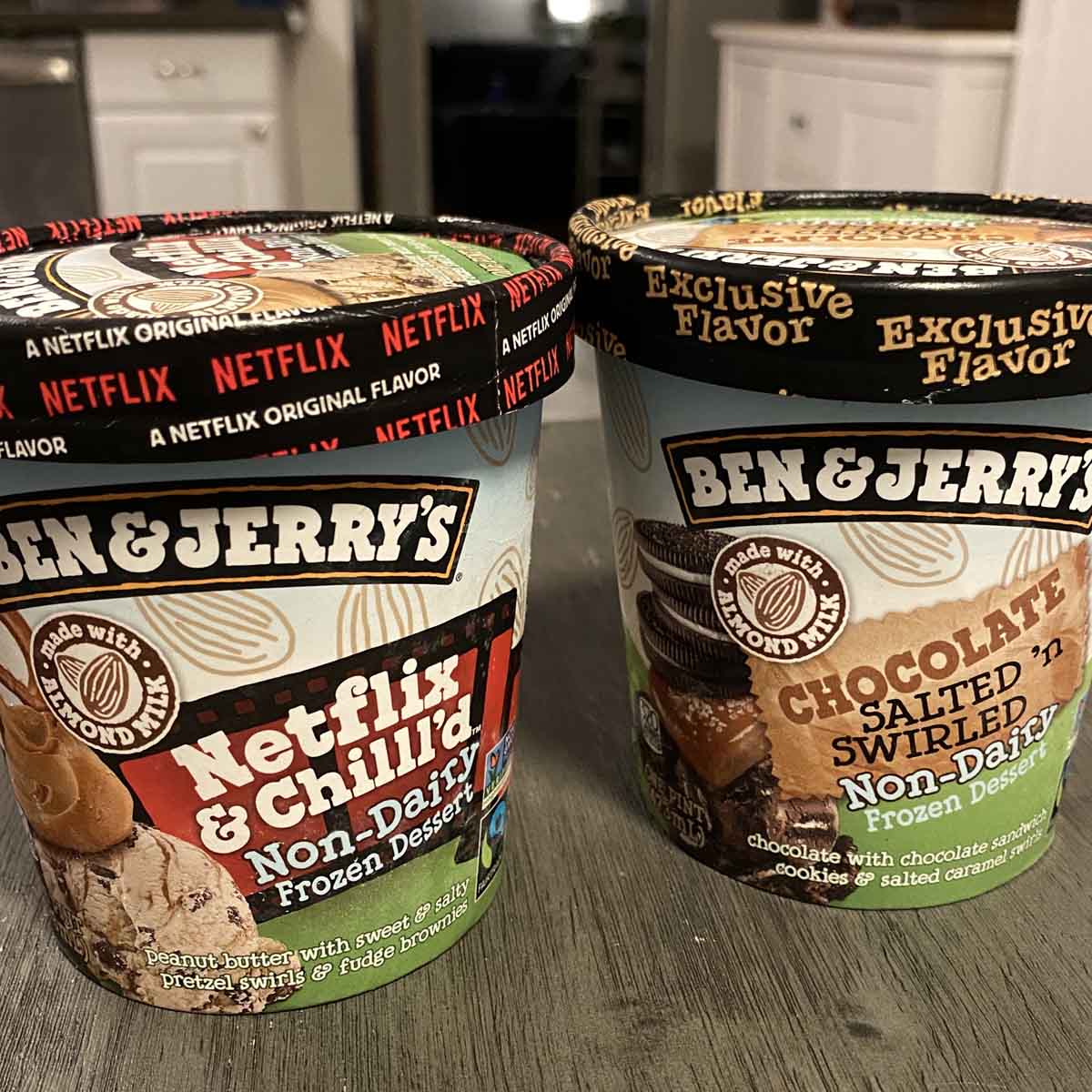 two pints of Ben & Jerry's non-dairy ice cream on a gray table in a white kitchen
