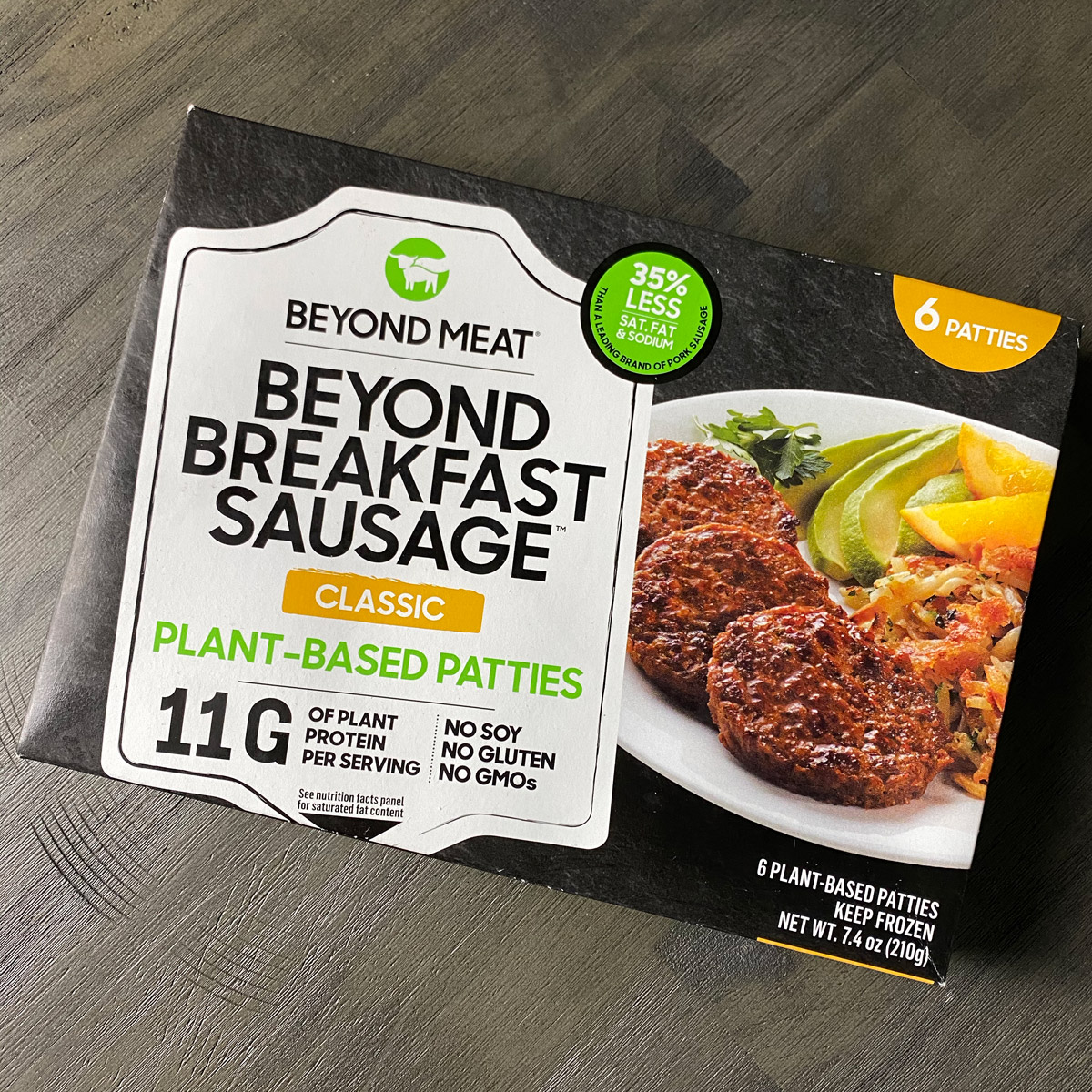 overhead photo of a box of Beyond Breakfast Sausage on a gray table