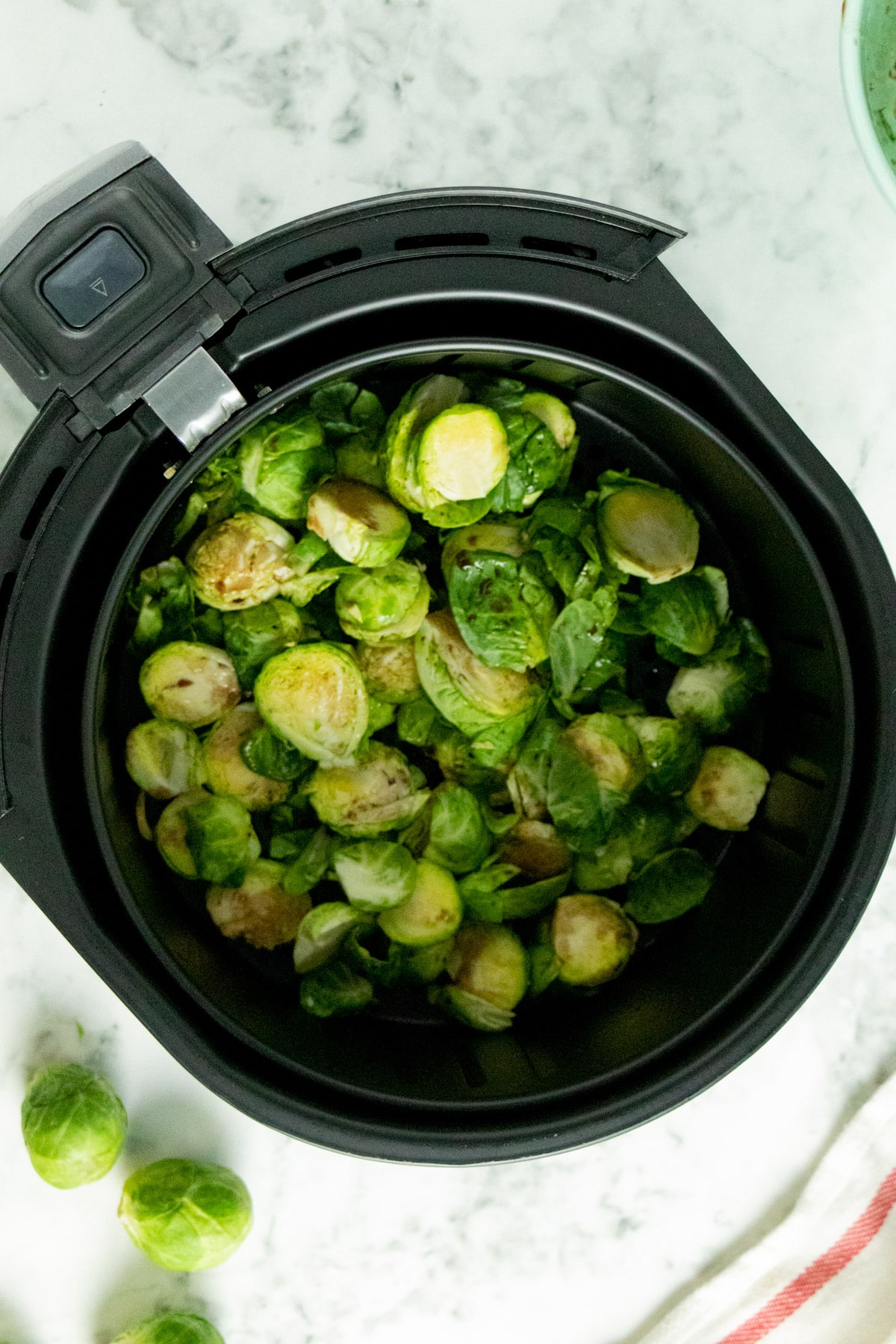 uncooked Brussels sprouts in the air fryer basket