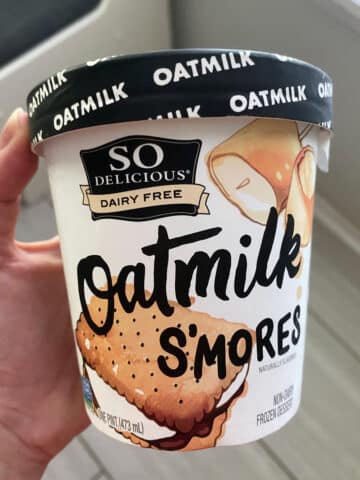 hand holding a pint of So Delicious Oatmilk S'mores vegan ice cream