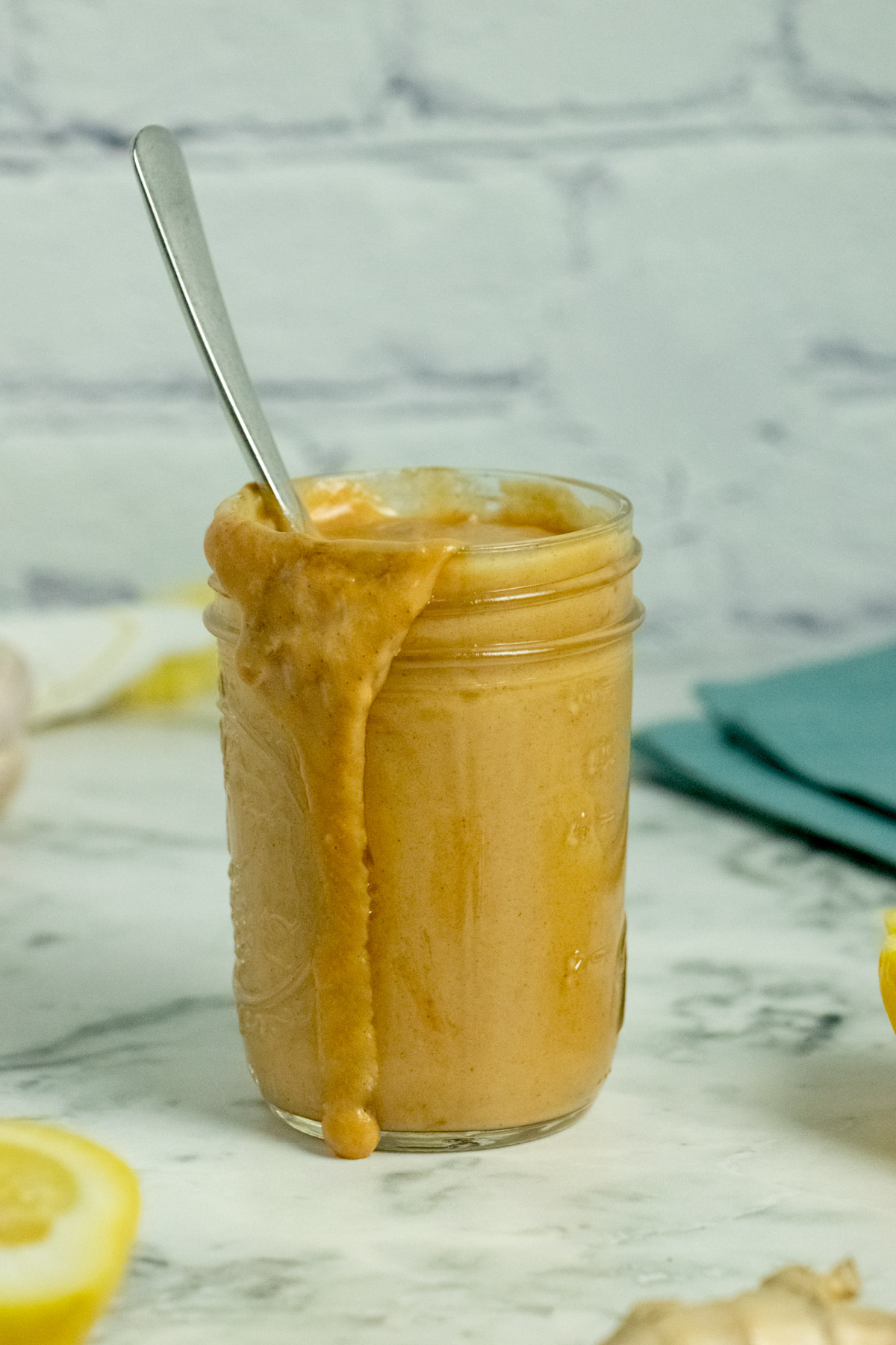 jar of peanut sauce with a bit of sauce spilling over one side, so you can see the creamy texture