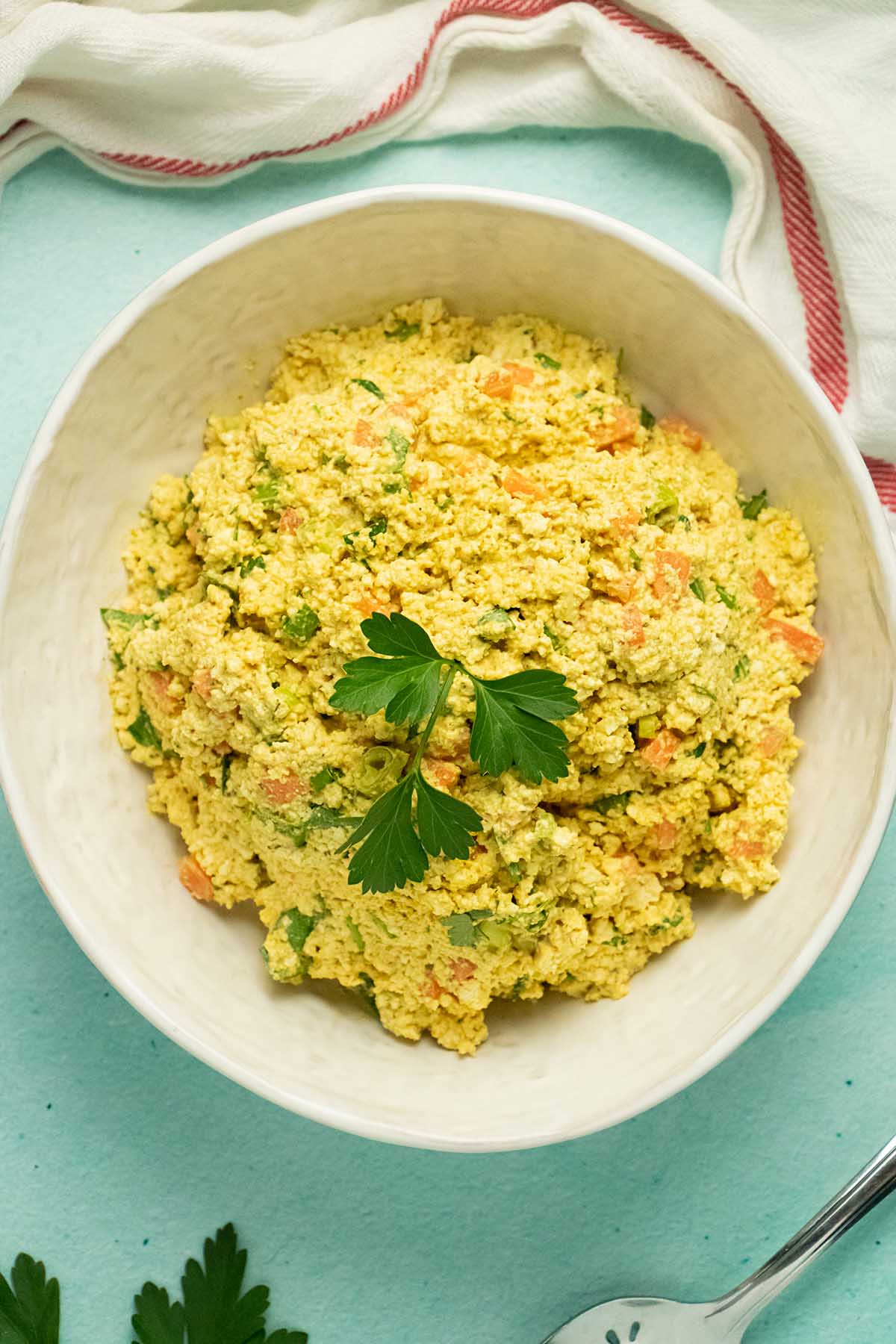 bowl of vegan egg salad with parsley garnish