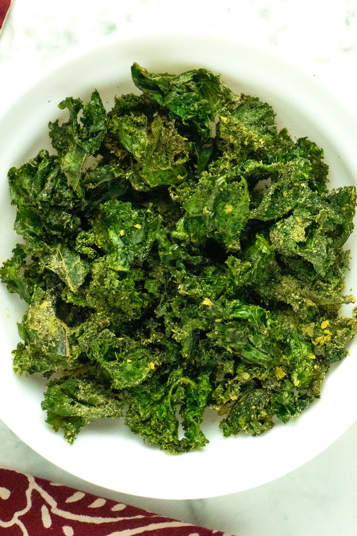 white bowl of air fryer kale chips flavored with ranch seasoning