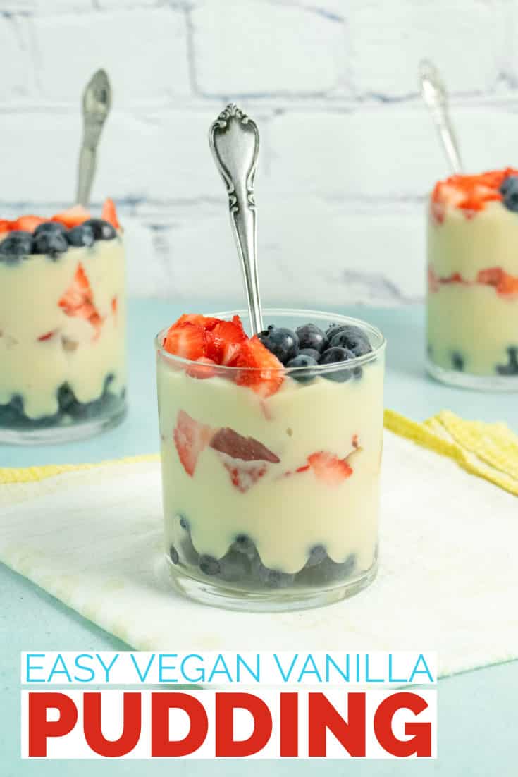 glasses of vegan vanilla pudding layered with strawberries and blueberries, text overlay