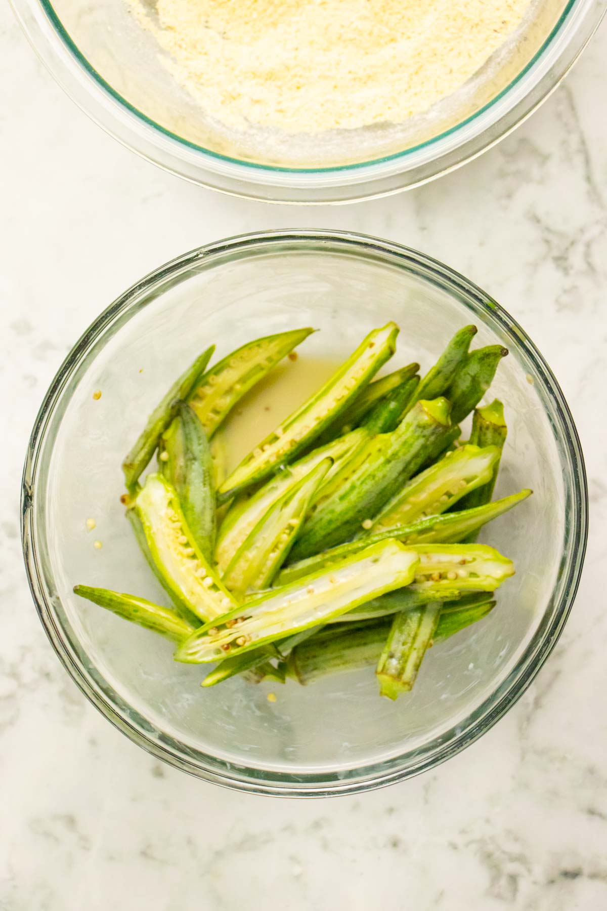 tossing the sliced okra with the vegan buttermilk