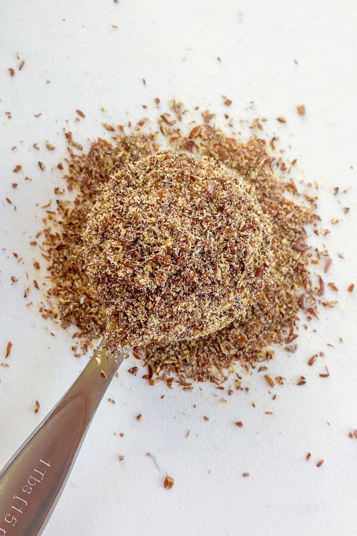 tablespoon of flax meal on a white cutting board