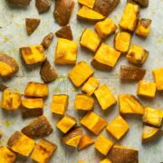 roasted sweet potato cubes on the baking sheet, fresh out of the oven