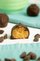 close-up of vegan peanut butter balls with a bite out of the one in the foreground