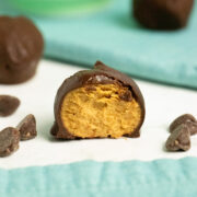 close-up of vegan peanut butter balls with a bite out of the one in the foreground
