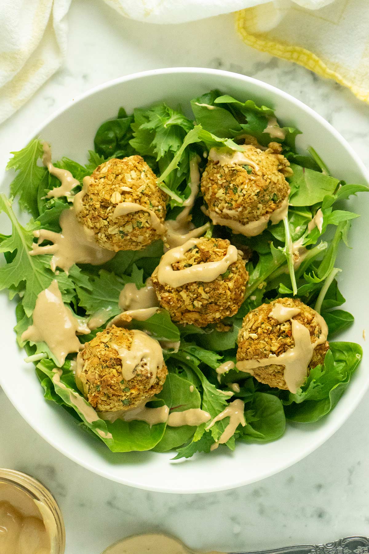 green salad topped with air fryer falafel