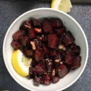 air fryer beets with a lemon wedge in a white bowl