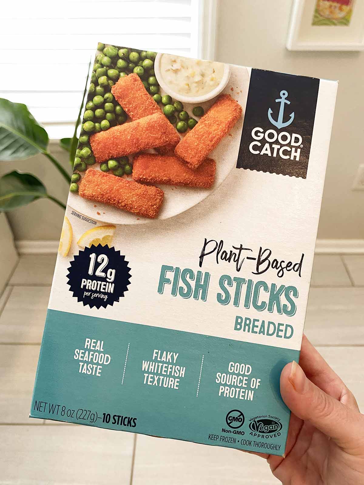 hand holding a box of Good Catch Plant Based Fish Sticks