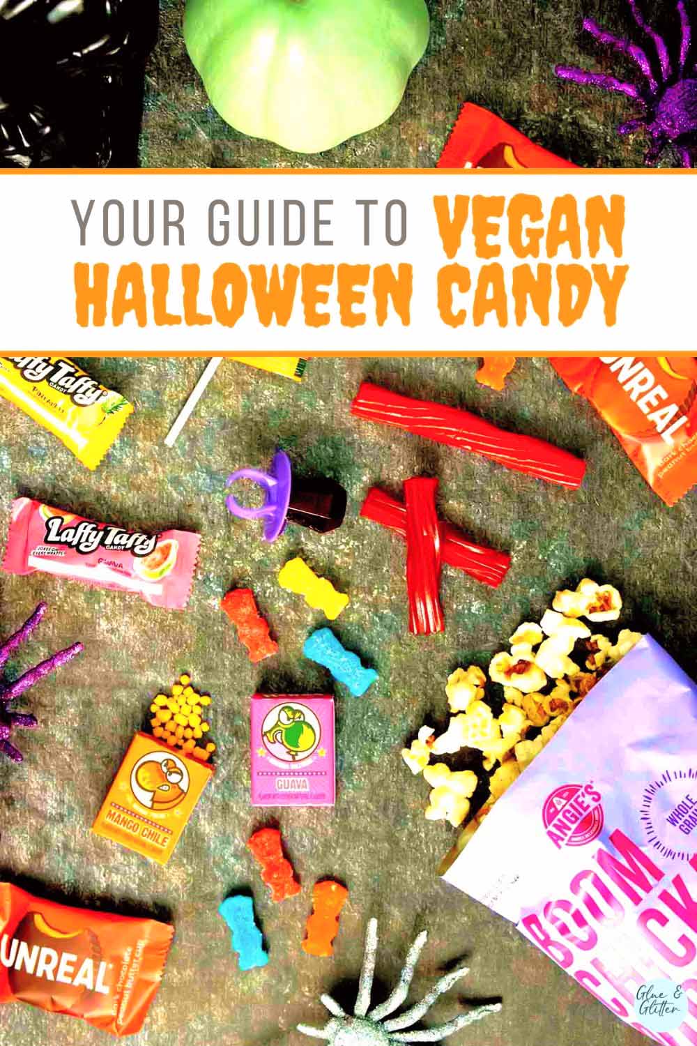 over-saturated image of vegan Halloween candy on a slate table with text that reads. "Your Guide to Vegan Halloween Candy"