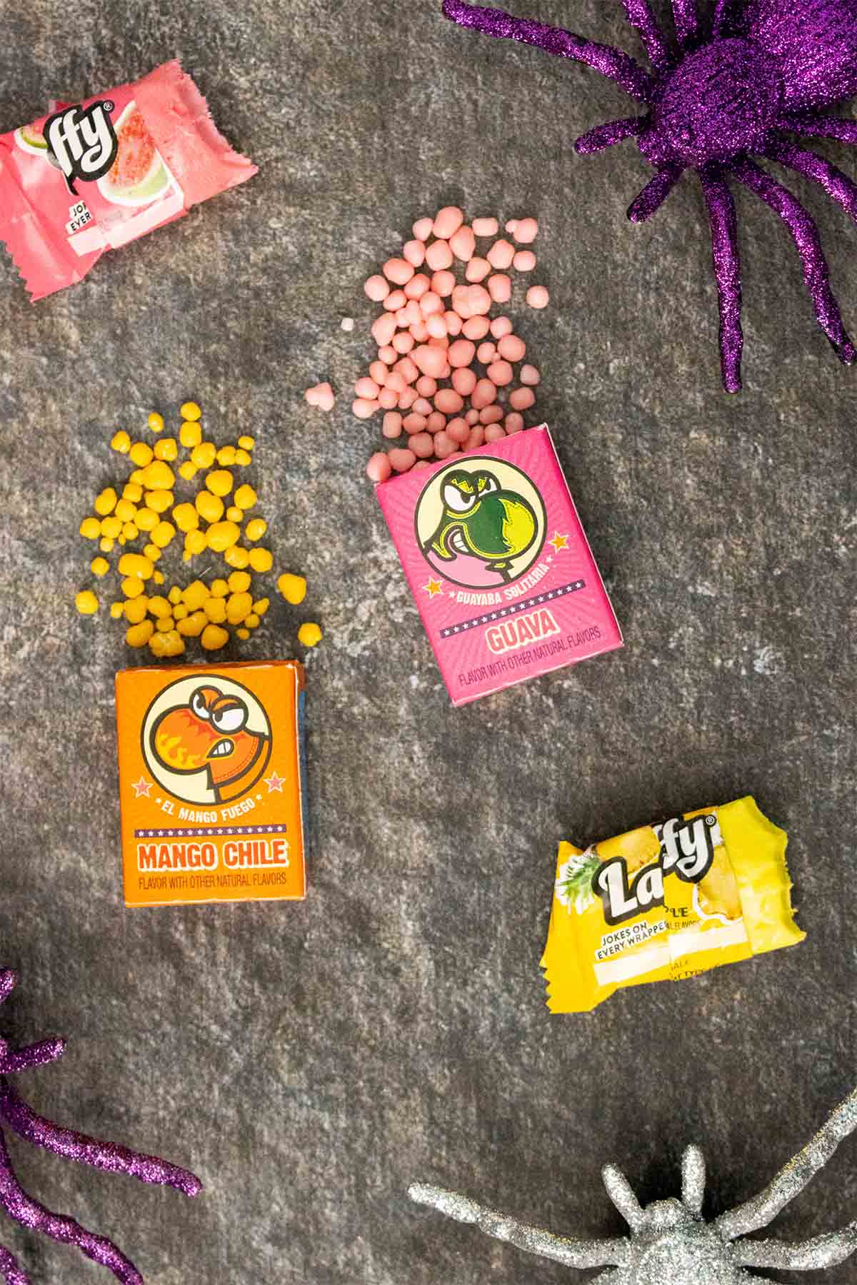 Nerds candy and Laffy Taffy on a table with some of the Nerds spilling out