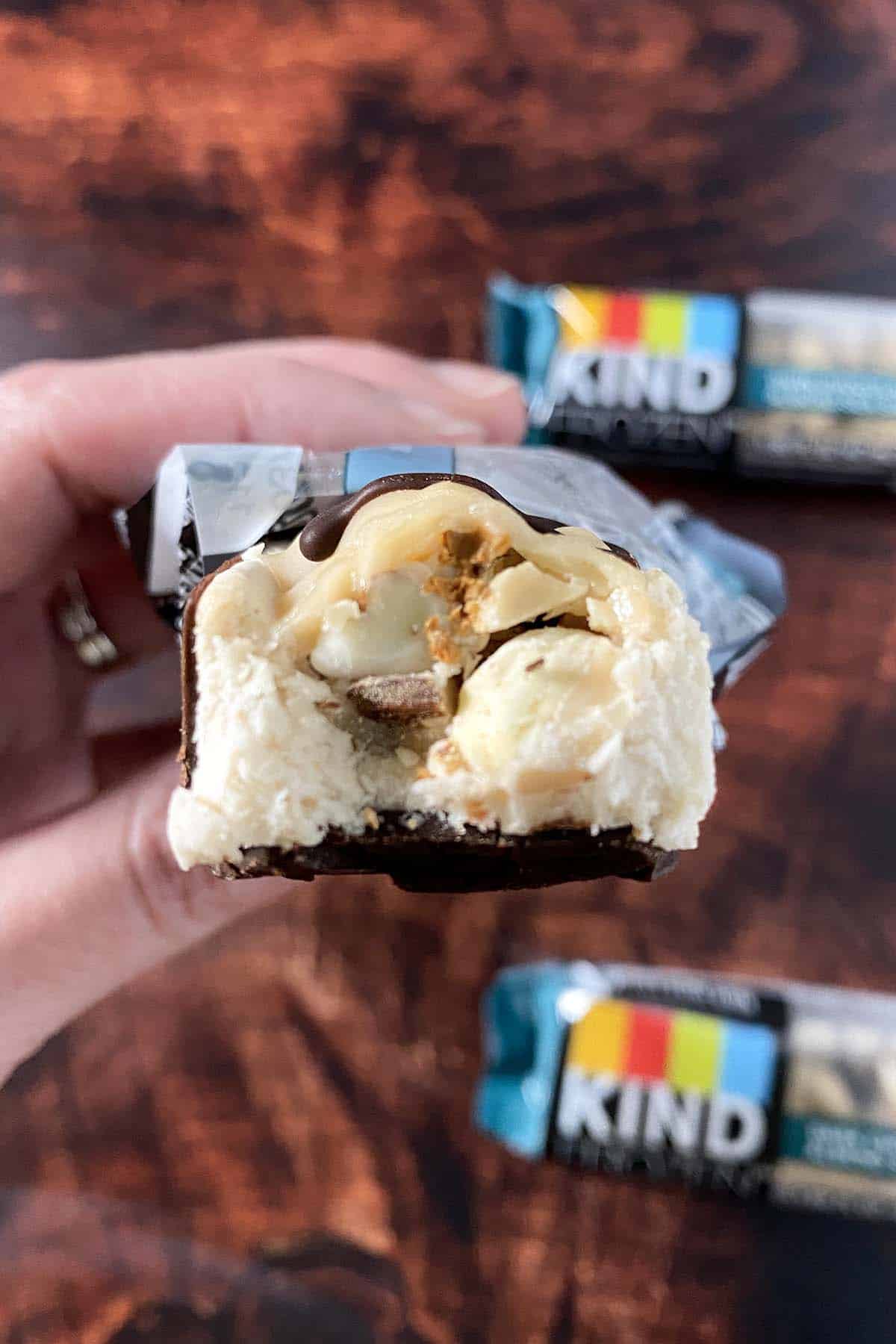 close-up of a KIND Frozen Treat Bar with a bite out, so you can see the inside