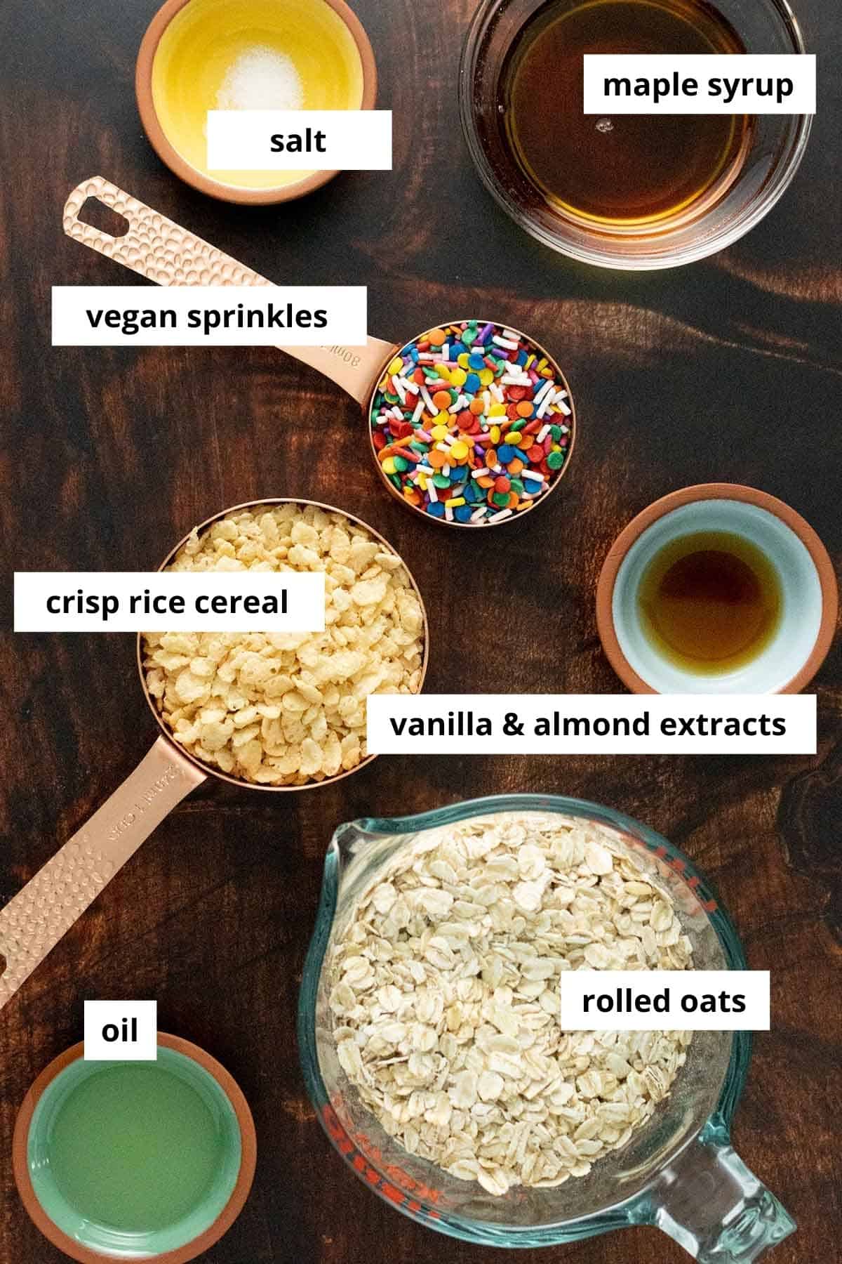 oats, rice cereal, sprinkles, and sauces on a wooden table