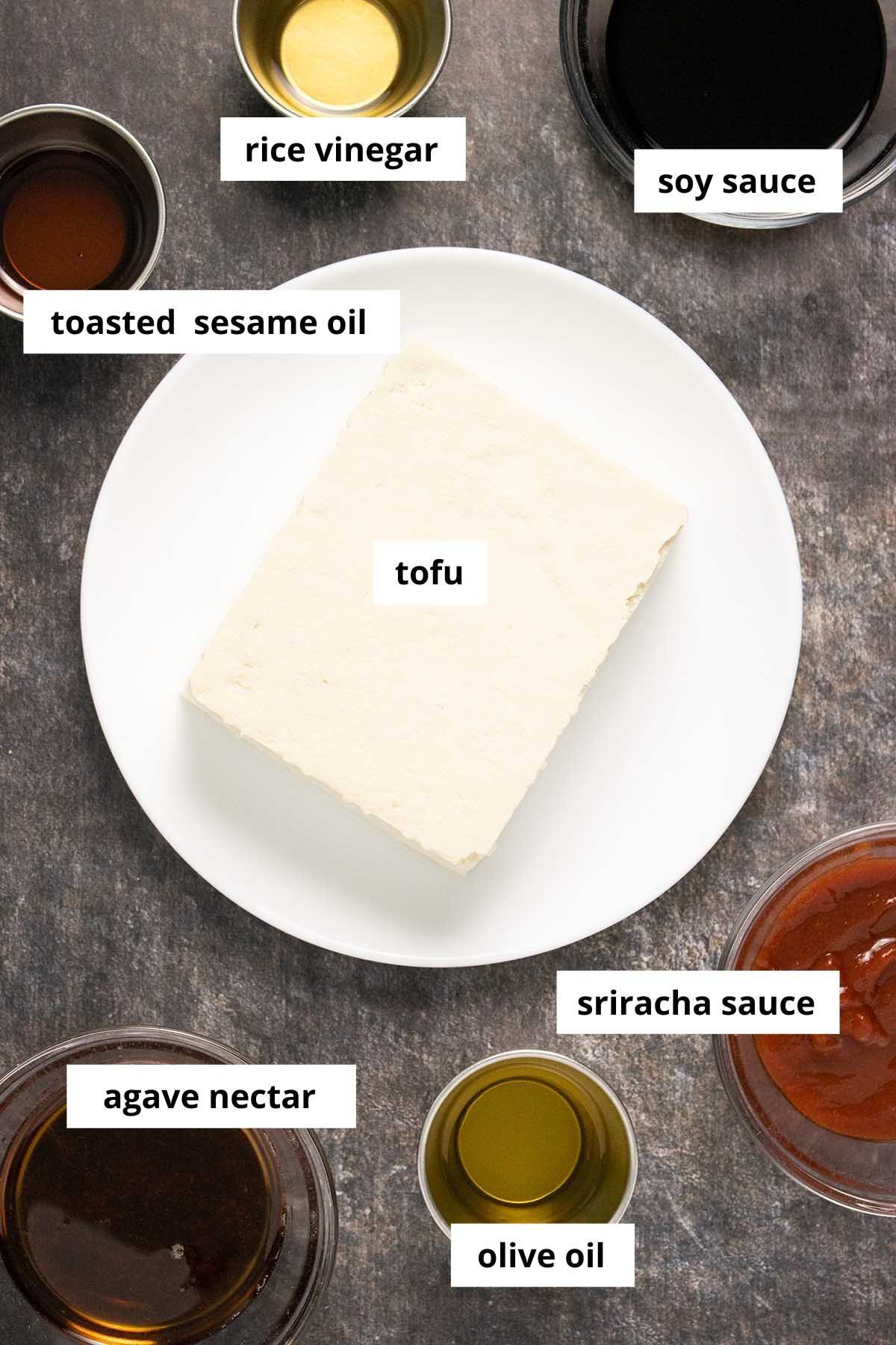 tofu surrounded by sauces on a slate table