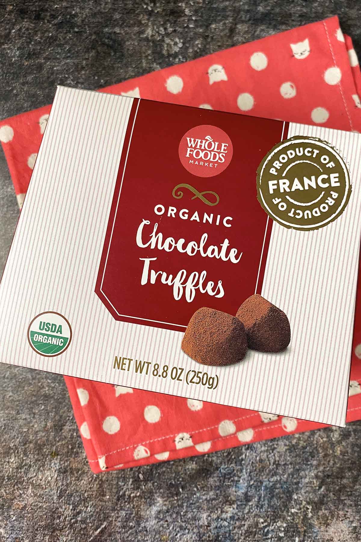 box of Whole Foods Organic Chocolate Truffles on a hot pink tea towel