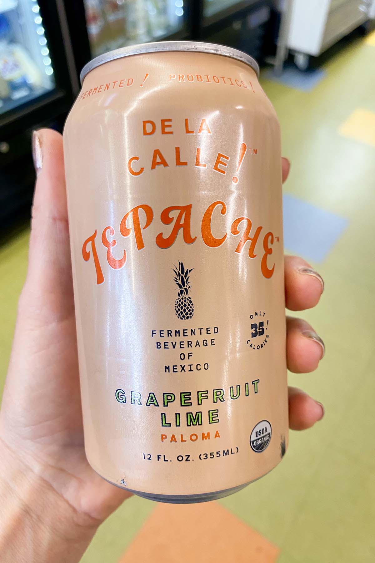 hand holding a can of non-alcoholic grapefruit Paloma tepache
