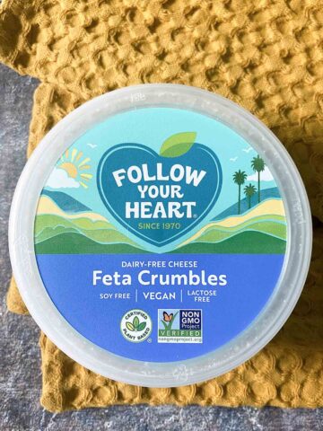 container of Follow Your Heart Feta on a yellow tea towel