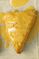 close-up of a scone with maple glaze on it