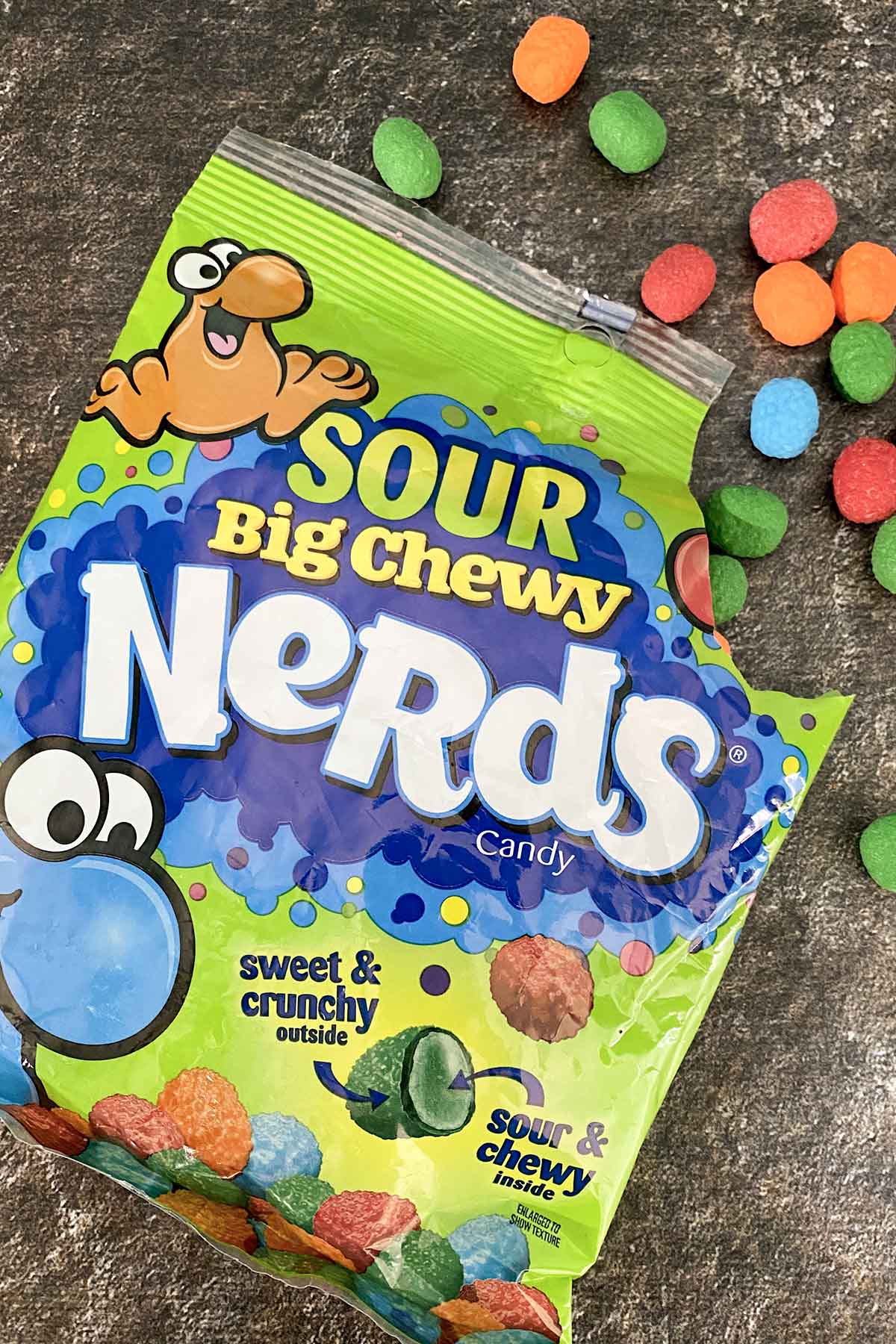 bag of Sour Big Chewy Nerds on a slate table with some of the candy spilling out