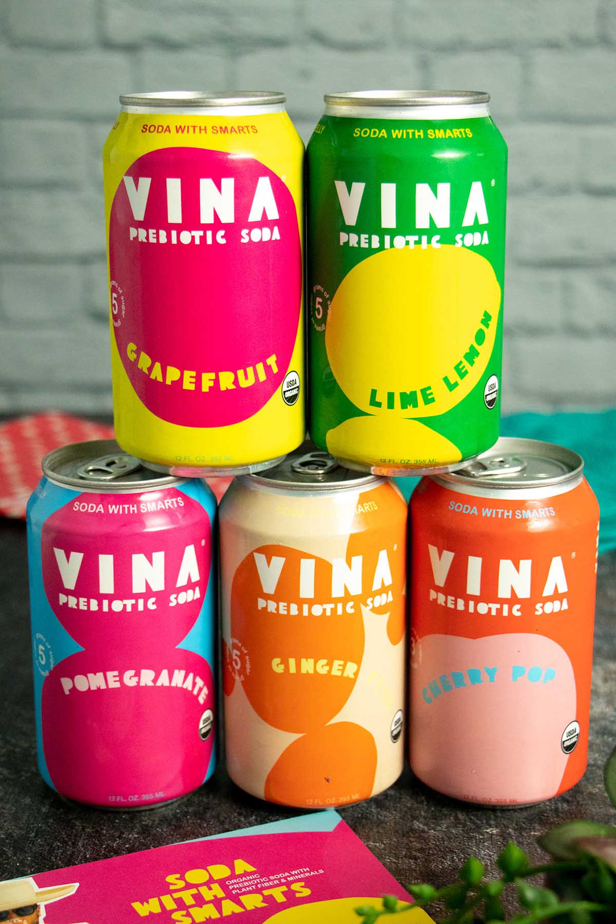 colorful cans of soda stacked up on a slate table