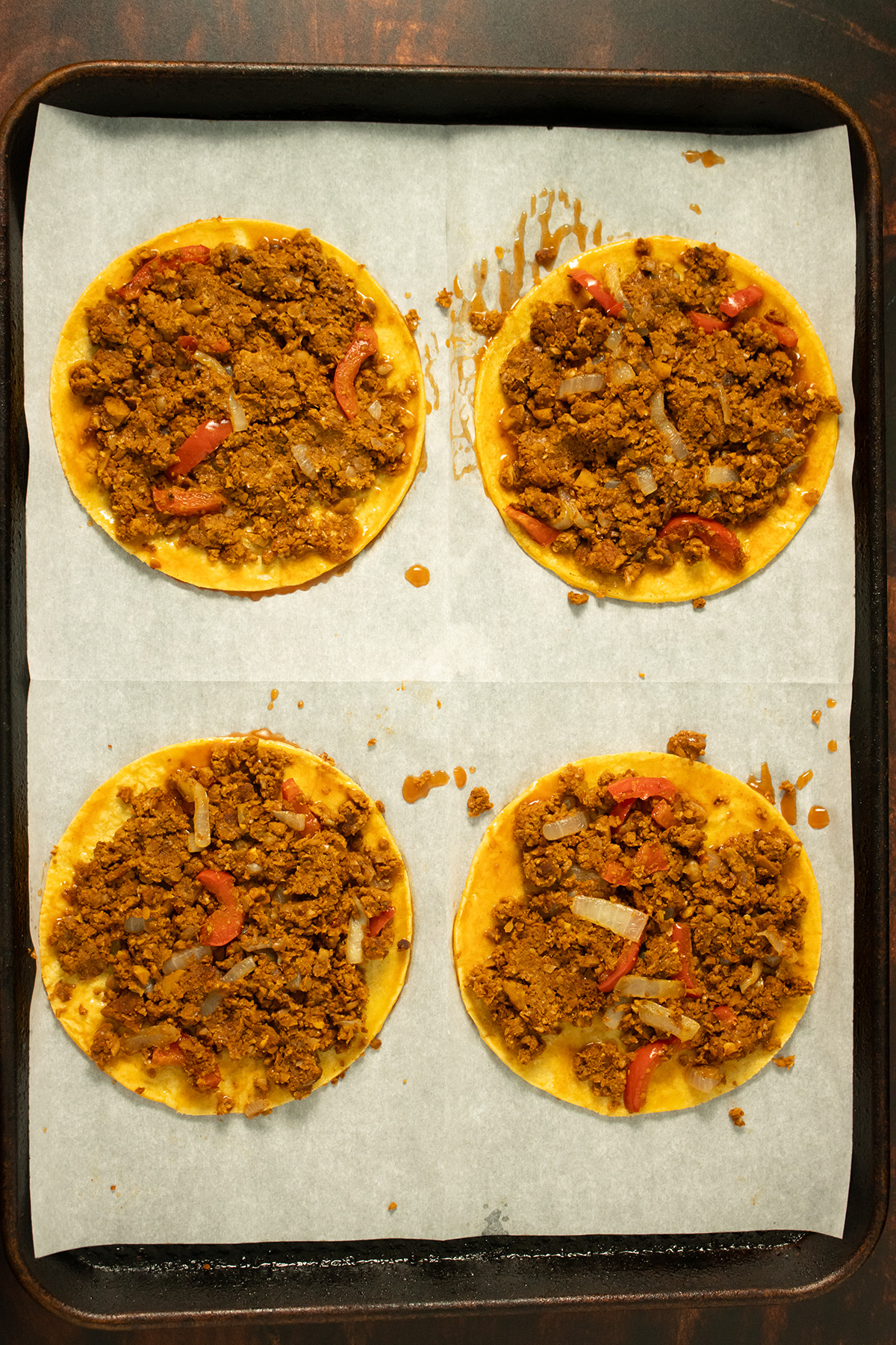 adding chorizo to the coated tortillas