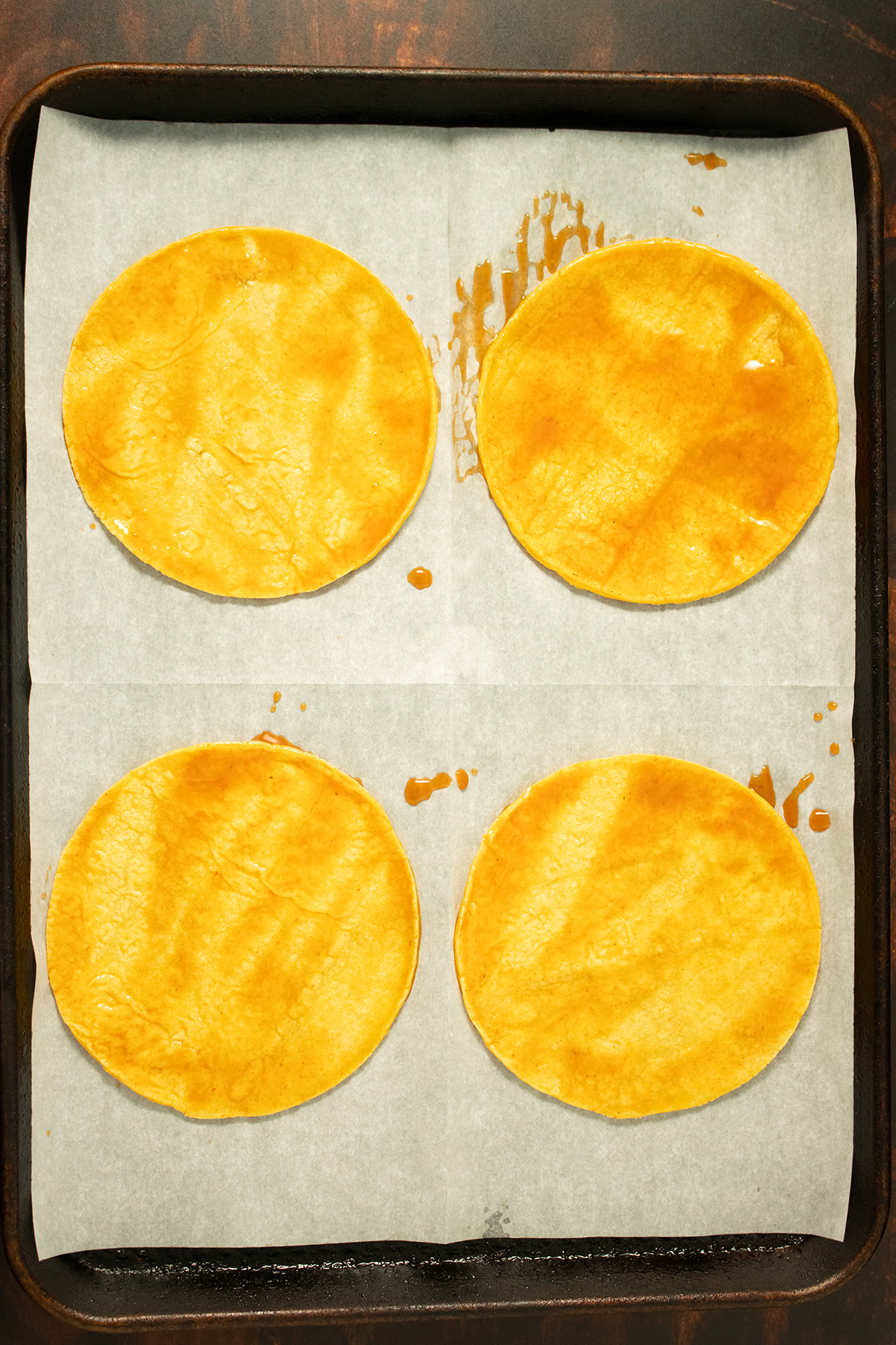 coated tortillas on a baking sheet