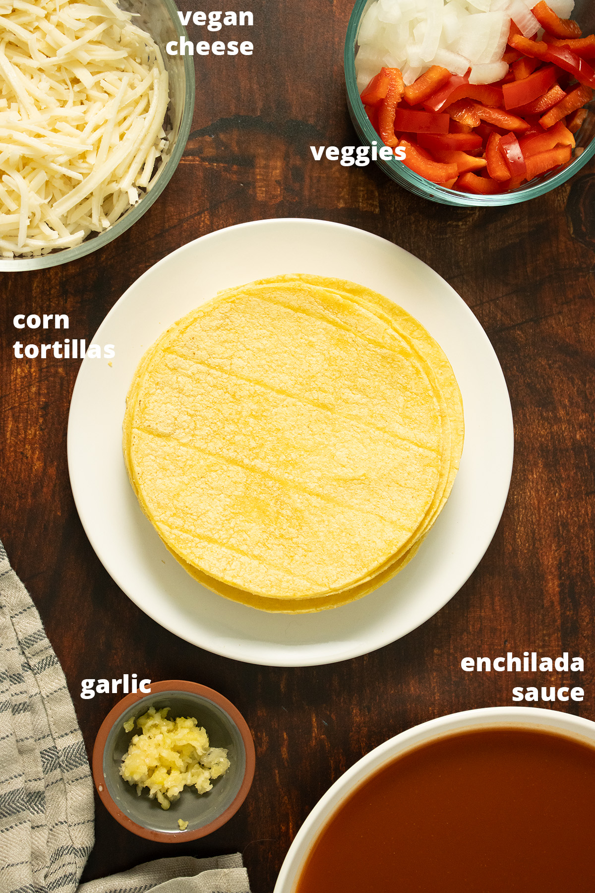 stacked enchiladas ingredients on a wooden table