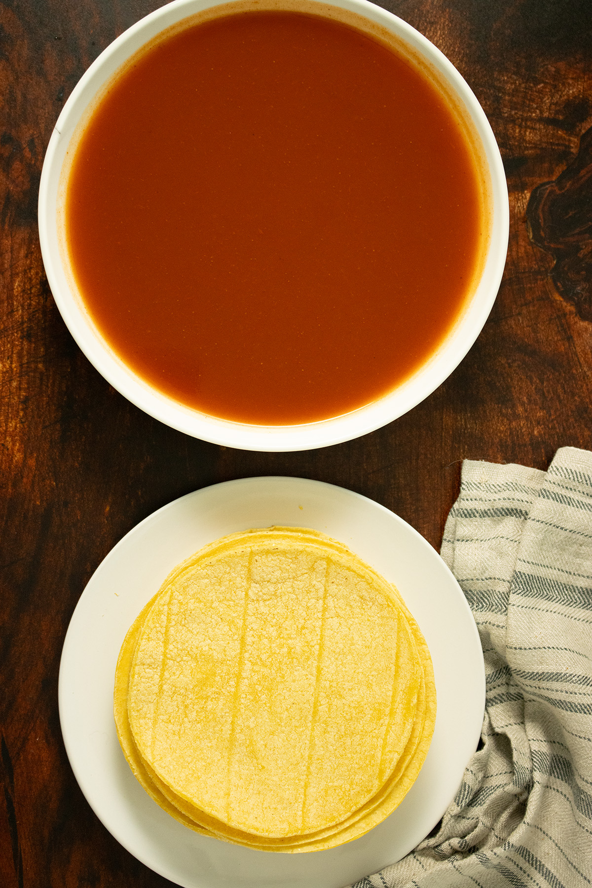 tortillas and enchilada sauce on a table