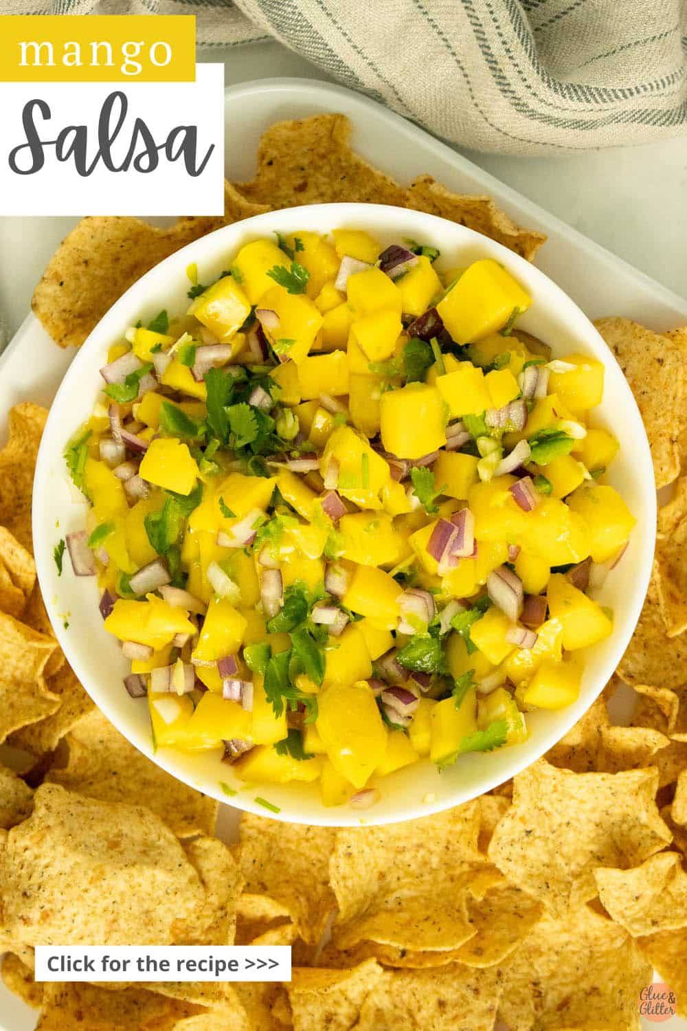 tray of chips with a bowl of mango salsa, text overlay