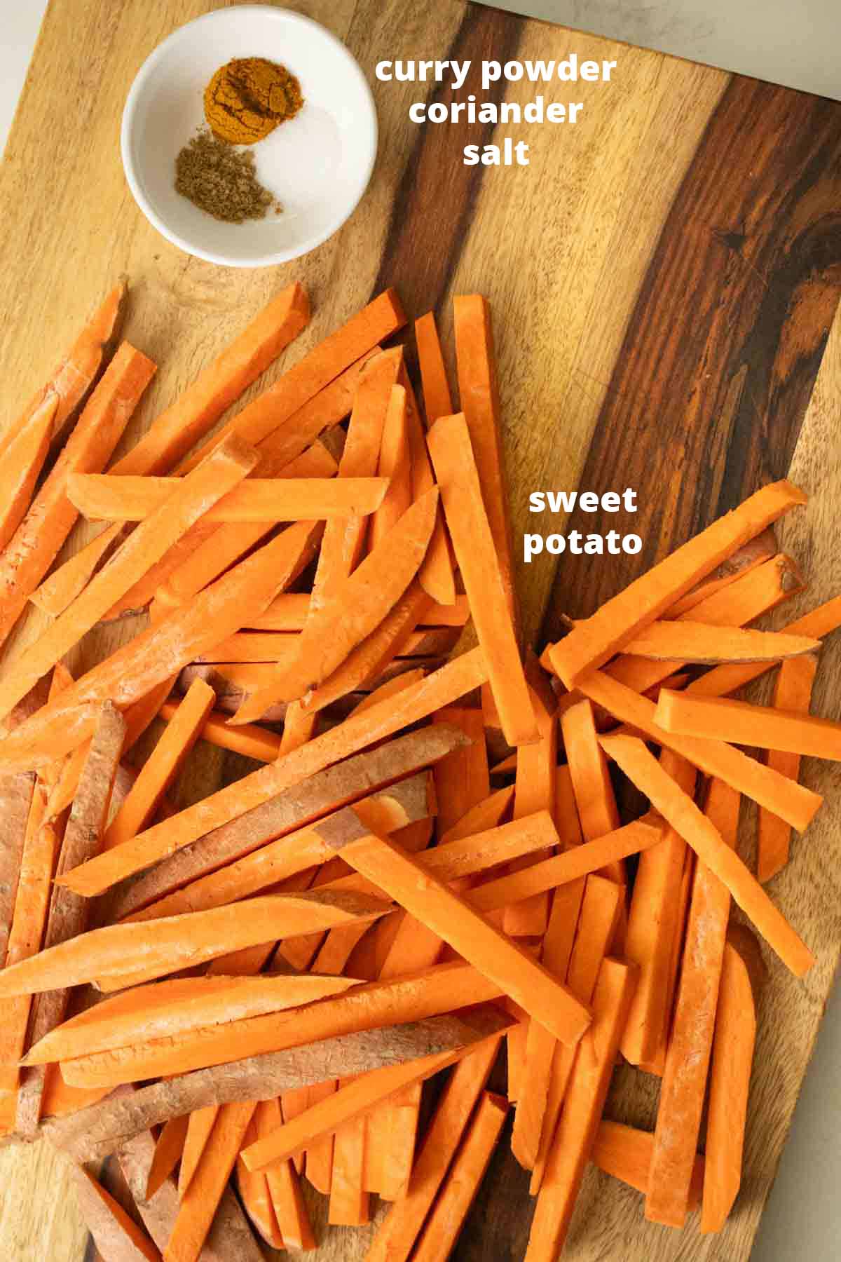 curried sweet potato oven fries ingredients on the cutting board, text labels