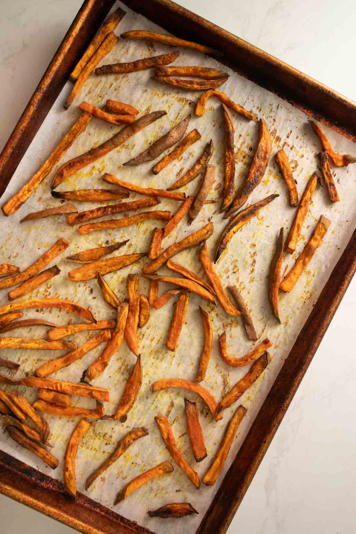 sweet potato fries on the baking sheet after baking
