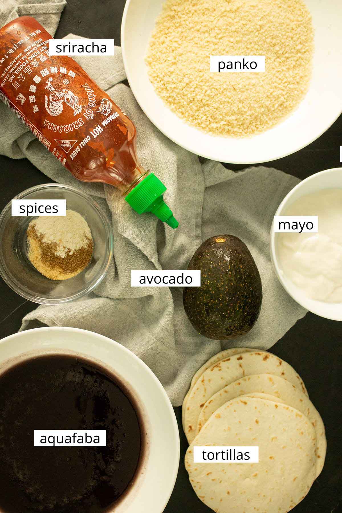 panko, aquafaba, and other ingredients for the tacos in bowls on a black table