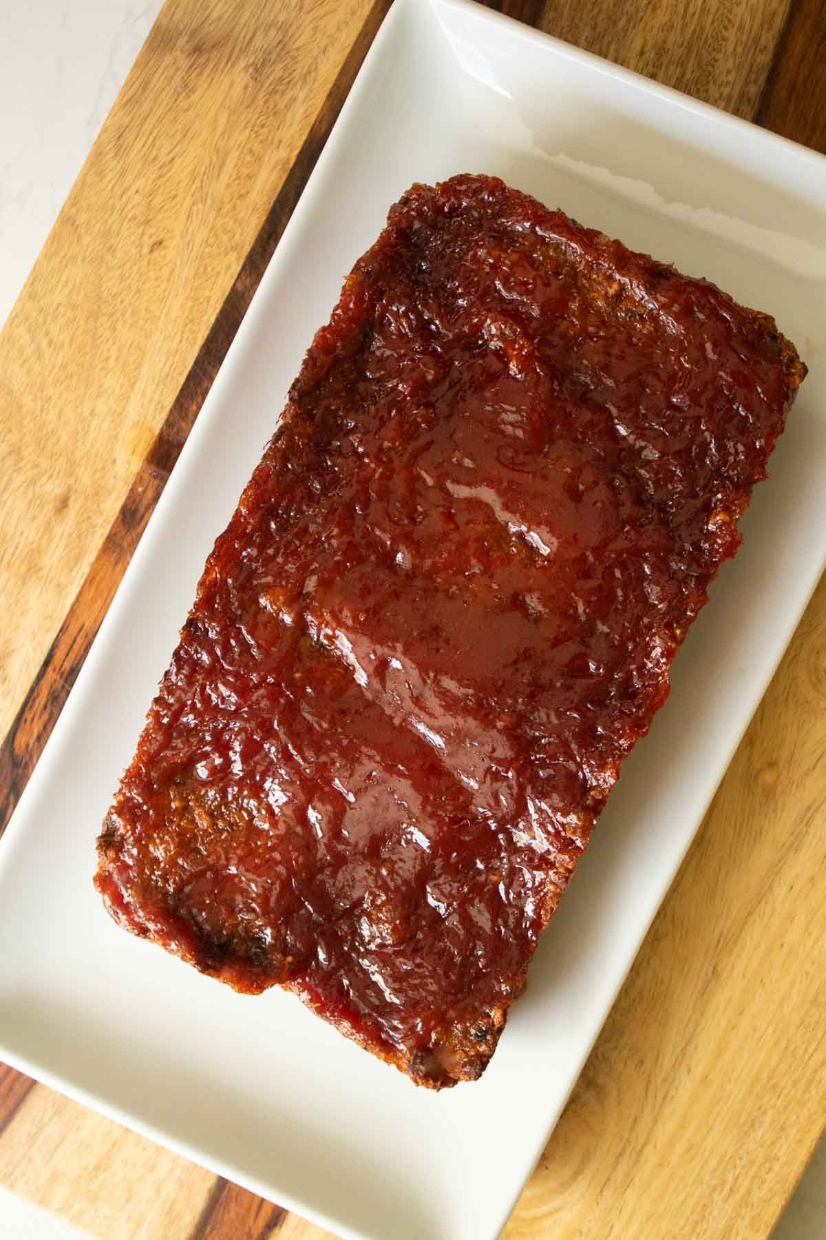 quinoa lentil meatloaf mixture with the glaze spread on, after baking